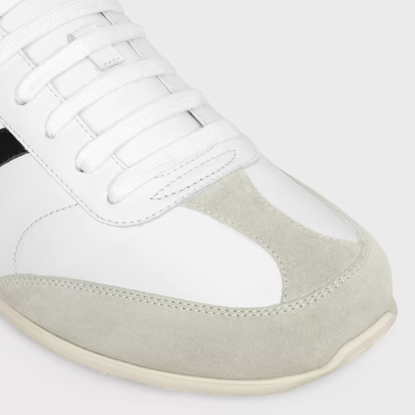 Shop CELINE JOGGER LOW LACE-UP SNEAKER WITH TRIOMPHE in CALFSKIN AND SUEDE CALFSKIN OPTICWHITE/GREY/BLACK